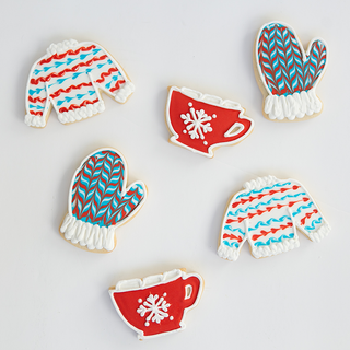 Winter sugar cookies decorated as mittens, sweaters, and mugs of hot cocoa.