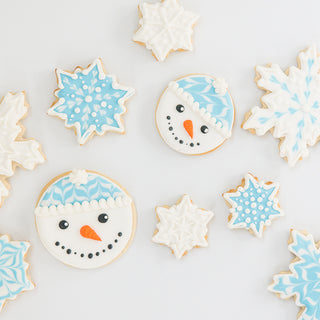 Blue and white snowflake and snowman sugar cookies decorated with royal icing
