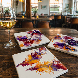 Fall fluid acrylic art tiles beside a glass of wine in a wine bar setting